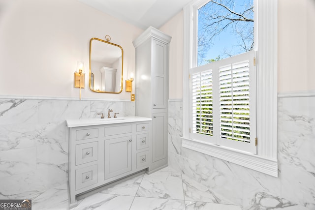 bathroom with vanity and tile walls