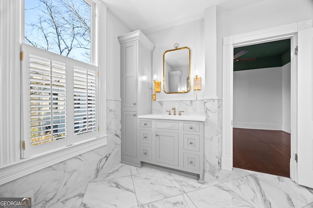 bathroom featuring vanity, tile walls, and ceiling fan