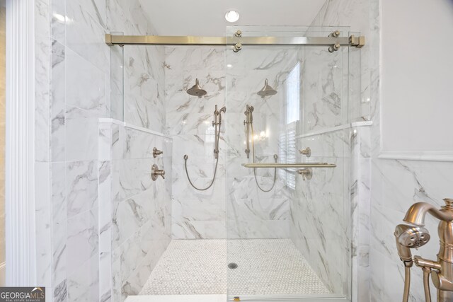 bathroom featuring an enclosed shower and tile walls