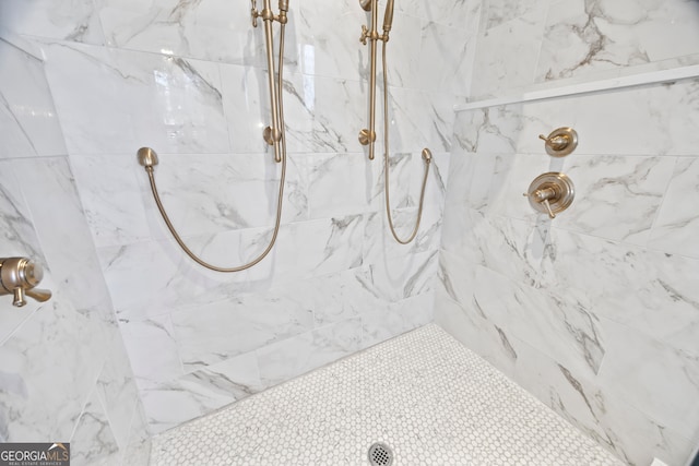 bathroom with a tile shower