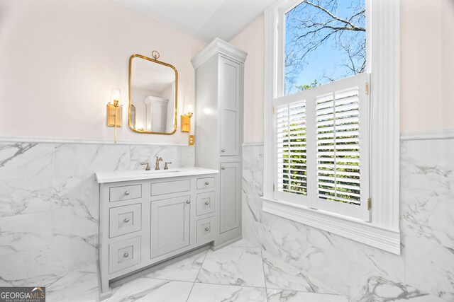198 Dearing St, Athens, GA 30605 - bathroom with tile walls, marble finish floor, vanity, and wainscoting