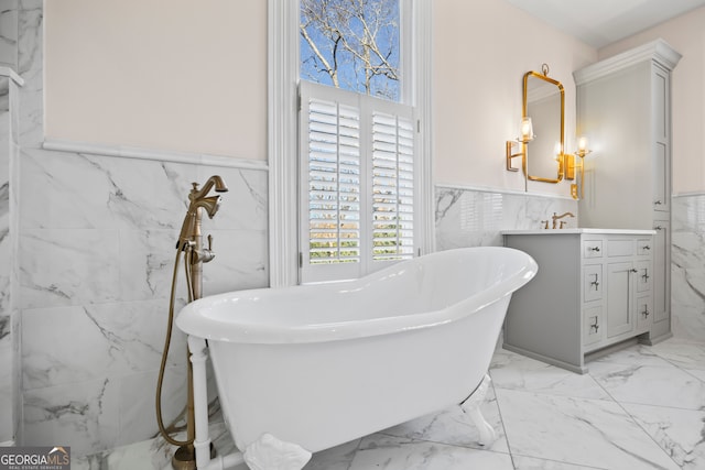 bathroom with a washtub, vanity, an inviting chandelier, and tile walls