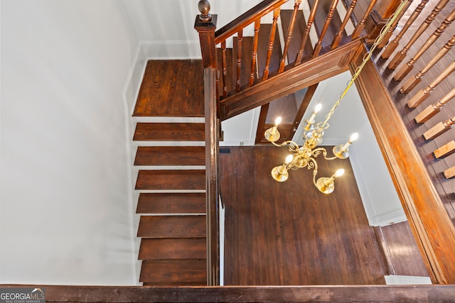 staircase featuring a notable chandelier