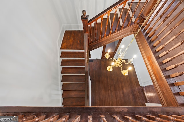 stairs with a notable chandelier