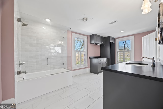 bathroom with vanity and shower / bath combination with glass door