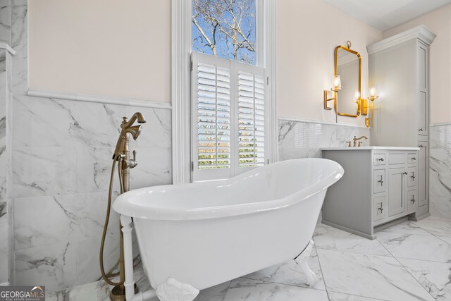 198 Dearing St, Athens, GA 30605 - bathroom with wainscoting, marble finish floor, vanity, and tile walls