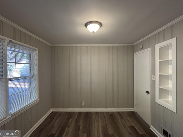 unfurnished room with dark wood-type flooring and crown molding