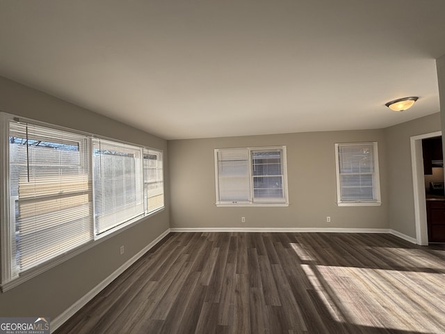 unfurnished room with dark hardwood / wood-style floors