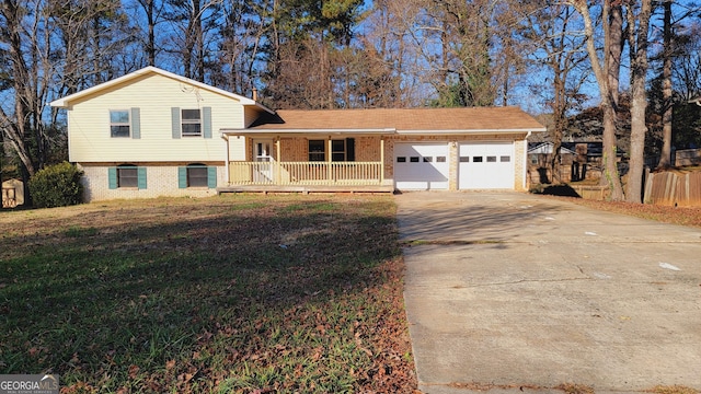 tri-level home with a front yard, a porch, and a garage