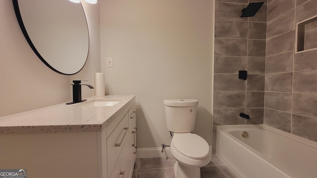 full bathroom featuring tiled shower / bath, tile patterned flooring, vanity, and toilet