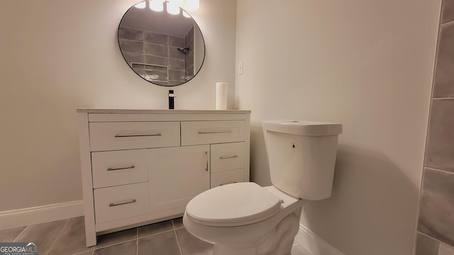 bathroom with tile patterned flooring, vanity, and toilet