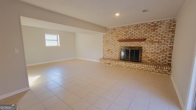 unfurnished living room featuring a textured ceiling, light tile patterned floors, and a fireplace