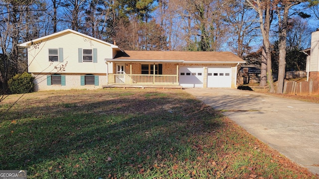 split level home featuring a front yard, a porch, and a garage