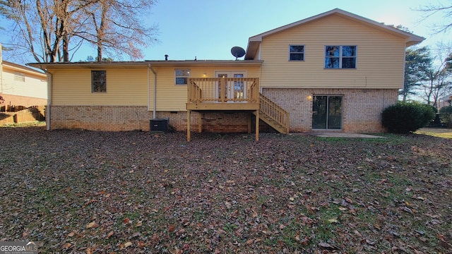 back of property featuring a deck and central AC