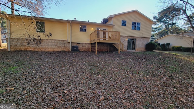 back of property featuring cooling unit and a wooden deck