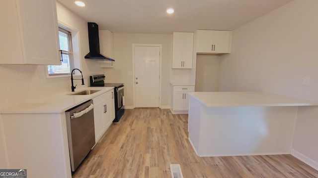 kitchen featuring wall chimney range hood, sink, black electric range, stainless steel dishwasher, and white cabinetry