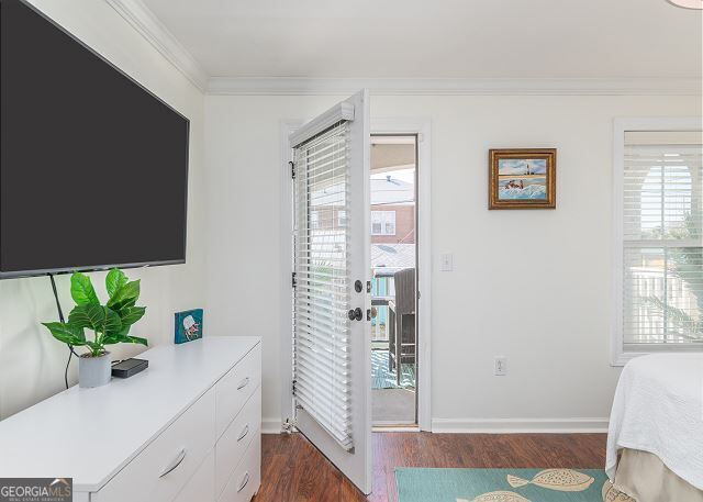 bedroom featuring dark hardwood / wood-style floors and ornamental molding