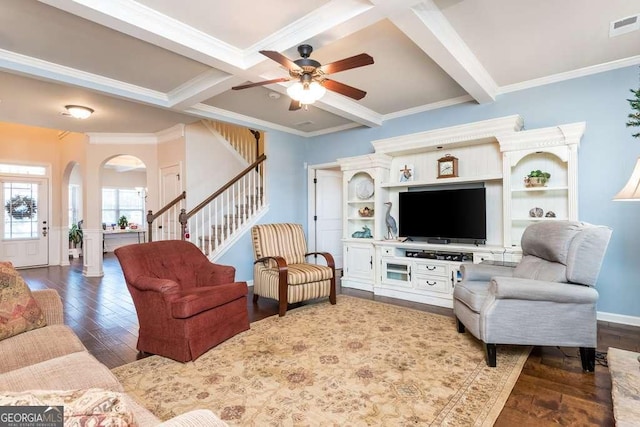 living room featuring beam ceiling, dark hardwood / wood-style floors, ceiling fan, and ornamental molding