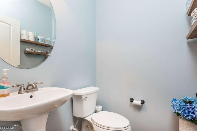 bathroom with toilet and sink