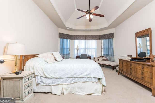 carpeted bedroom featuring a tray ceiling, ceiling fan, and lofted ceiling