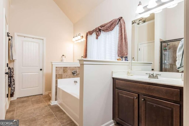 bathroom with a bathtub, vanity, and lofted ceiling