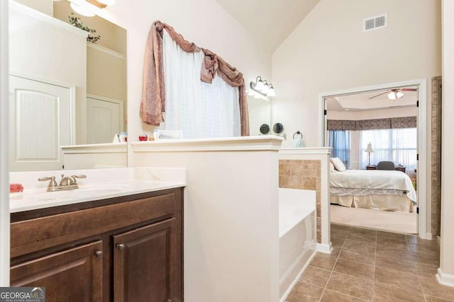 bathroom featuring vanity, a bath, high vaulted ceiling, tile patterned flooring, and ceiling fan