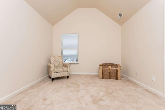 sitting room with carpet and lofted ceiling