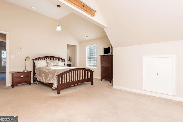 carpeted bedroom featuring lofted ceiling