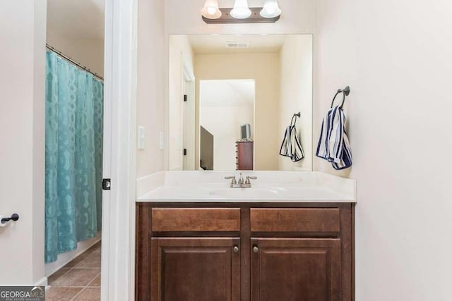 bathroom featuring tile patterned flooring, vanity, and a shower with shower curtain