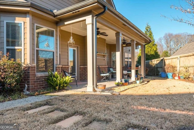 doorway to property with ceiling fan and a patio area