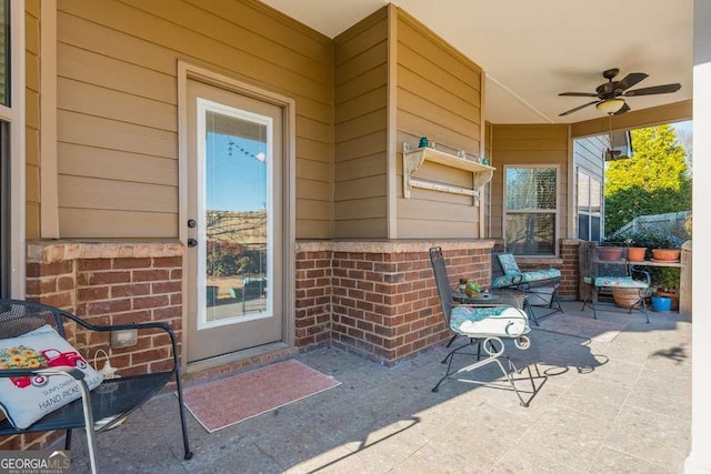 property entrance with ceiling fan and a patio