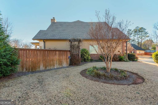 view of side of property with a lawn