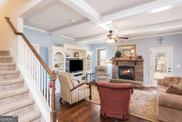 living room with a fireplace, beam ceiling, dark wood-type flooring, and a healthy amount of sunlight