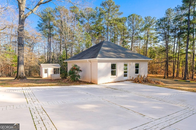 view of property exterior featuring a storage shed