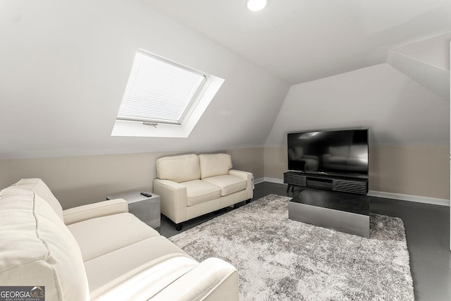 living room with vaulted ceiling with skylight