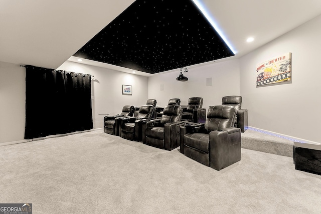 cinema featuring a raised ceiling and carpet floors