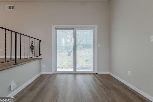 unfurnished room featuring hardwood / wood-style floors and a wealth of natural light