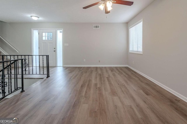 spare room with light hardwood / wood-style floors and ceiling fan