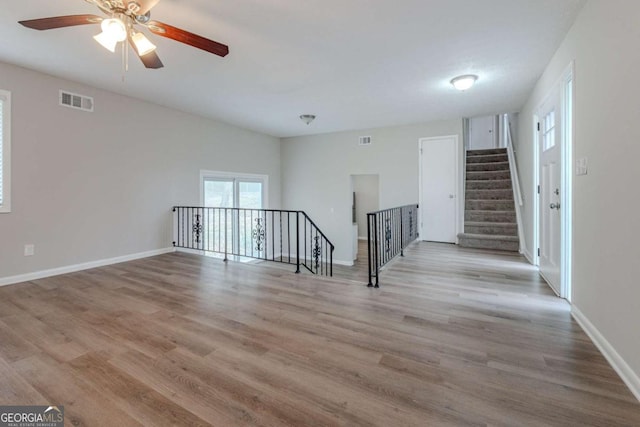 spare room with ceiling fan and light wood-type flooring