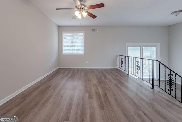 empty room featuring ceiling fan and light wood-type flooring