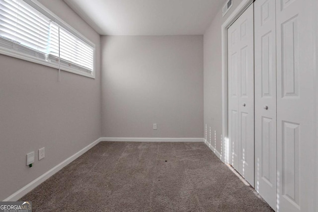 unfurnished bedroom featuring dark colored carpet