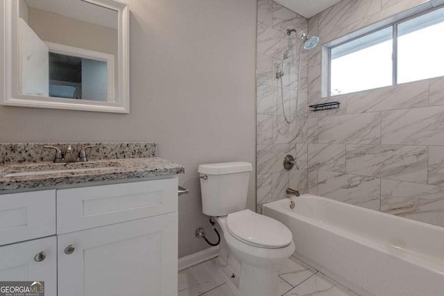 full bathroom with toilet, vanity, and tiled shower / bath