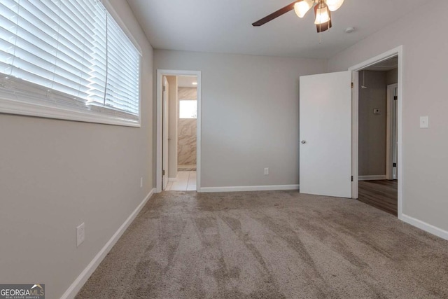 unfurnished bedroom with light carpet, connected bathroom, and ceiling fan