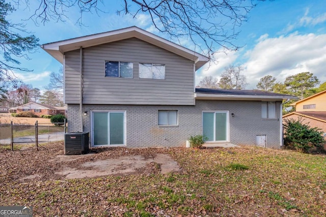 rear view of property with central AC