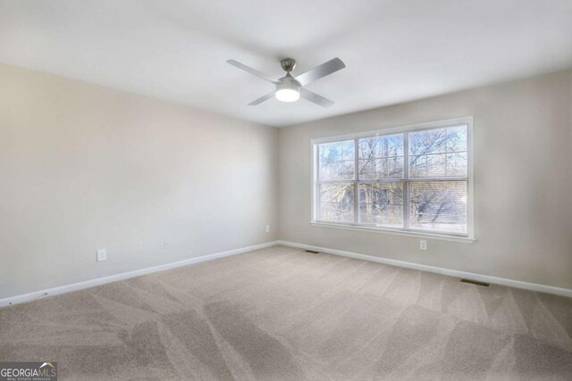 empty room with carpet flooring and ceiling fan