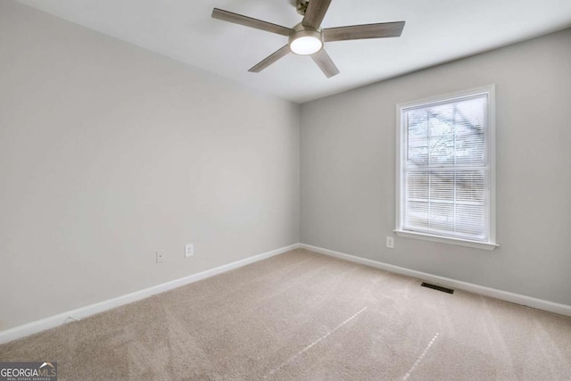 spare room with carpet and ceiling fan