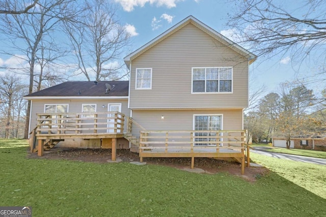 rear view of property featuring a lawn and a wooden deck