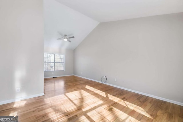 empty room with light wood-type flooring, vaulted ceiling, and ceiling fan