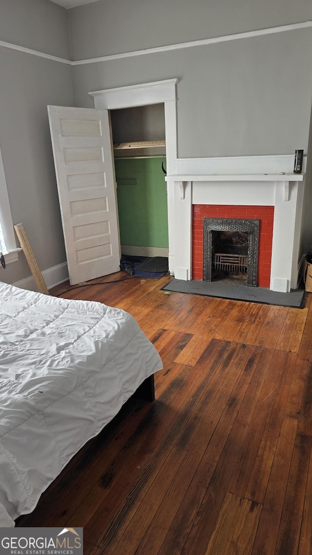 bedroom with dark wood-type flooring and a closet