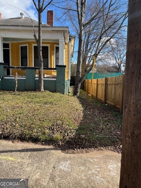 view of side of property featuring covered porch